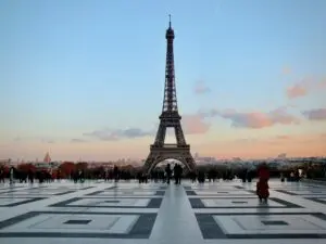 Limousine de luxe avec chauffeur devant la Tour Eiffel à Paris.